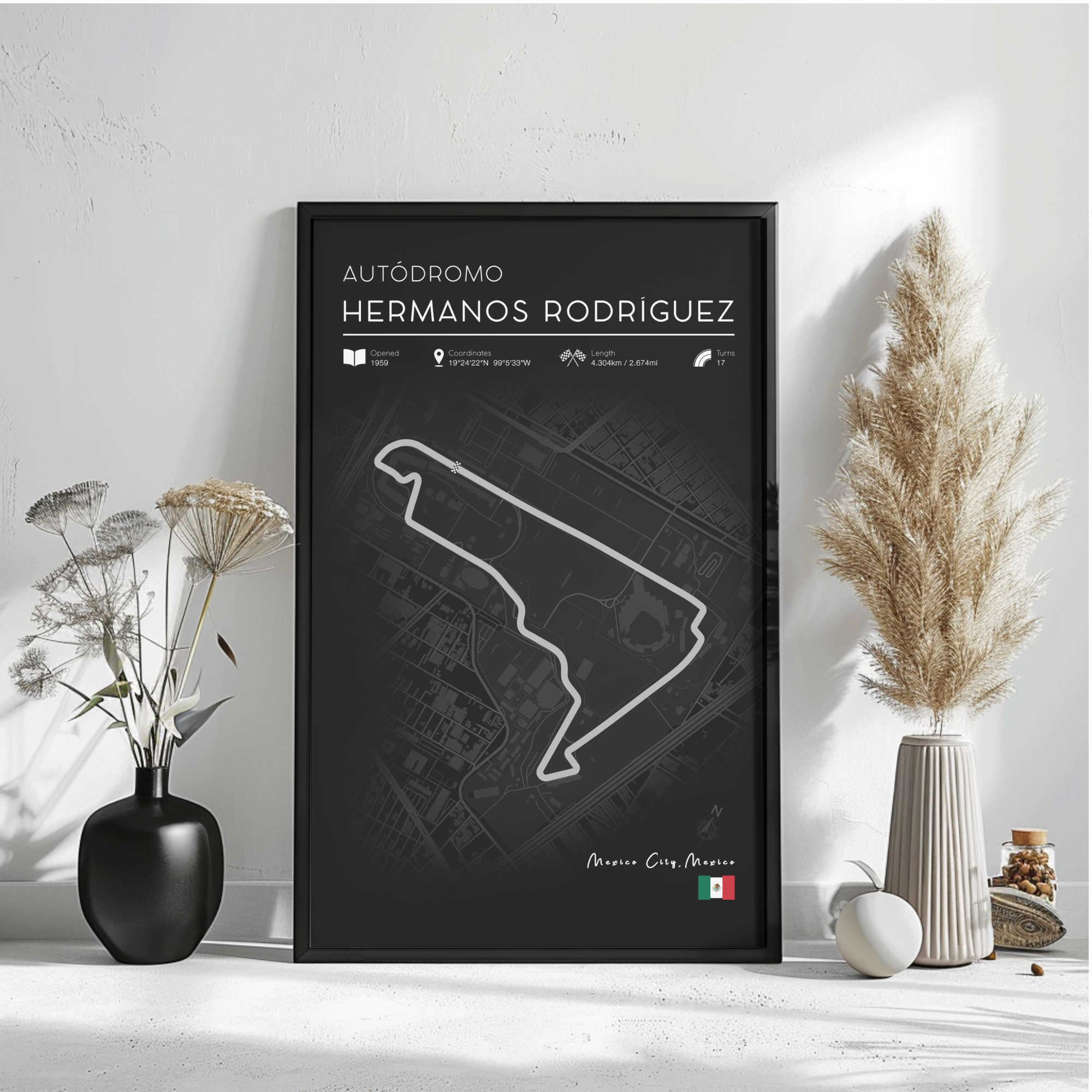 a poster of a race track map with a black background and white outline, placed on a white wall next to a vase with flowers and a potted plant.