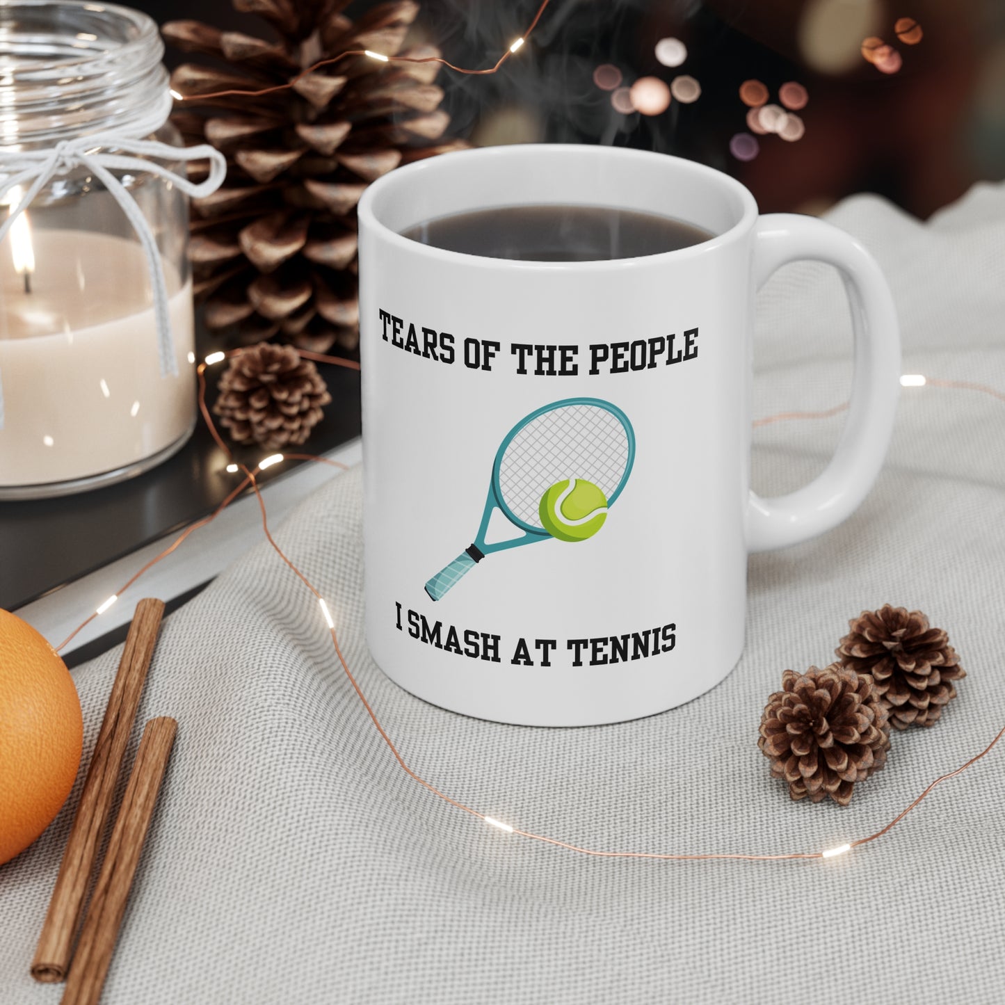 White ceramic mug with a tennis racket and ball illustration and the text “Tears of the People I Smash at Tennis” – funny mug for tennis players.