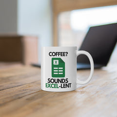 White ceramic mug with a green spreadsheet icon and the phrase “Coffee? Sounds Excel-lent” – a funny gift for office workers or Excel users.