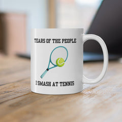 White ceramic mug with a tennis racket and ball illustration and the text “Tears of the People I Smash at Tennis” – funny mug for tennis players.