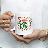 Person holding a mug with 'Santa's Favourite Wife' text