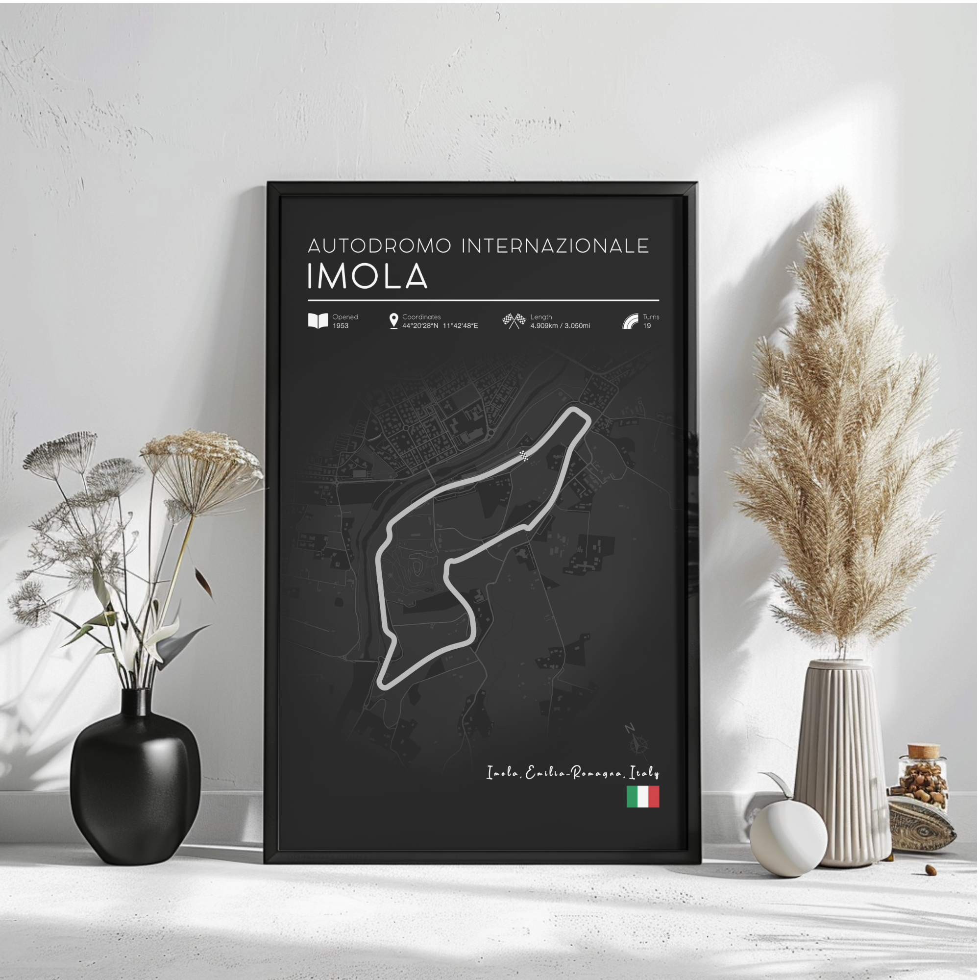a poster of the Imola race track in Italy, with a black background and a white outline of the track. The poster includes text and a map of the race track, as well as some decorative elements such as a potted plant and a vase.