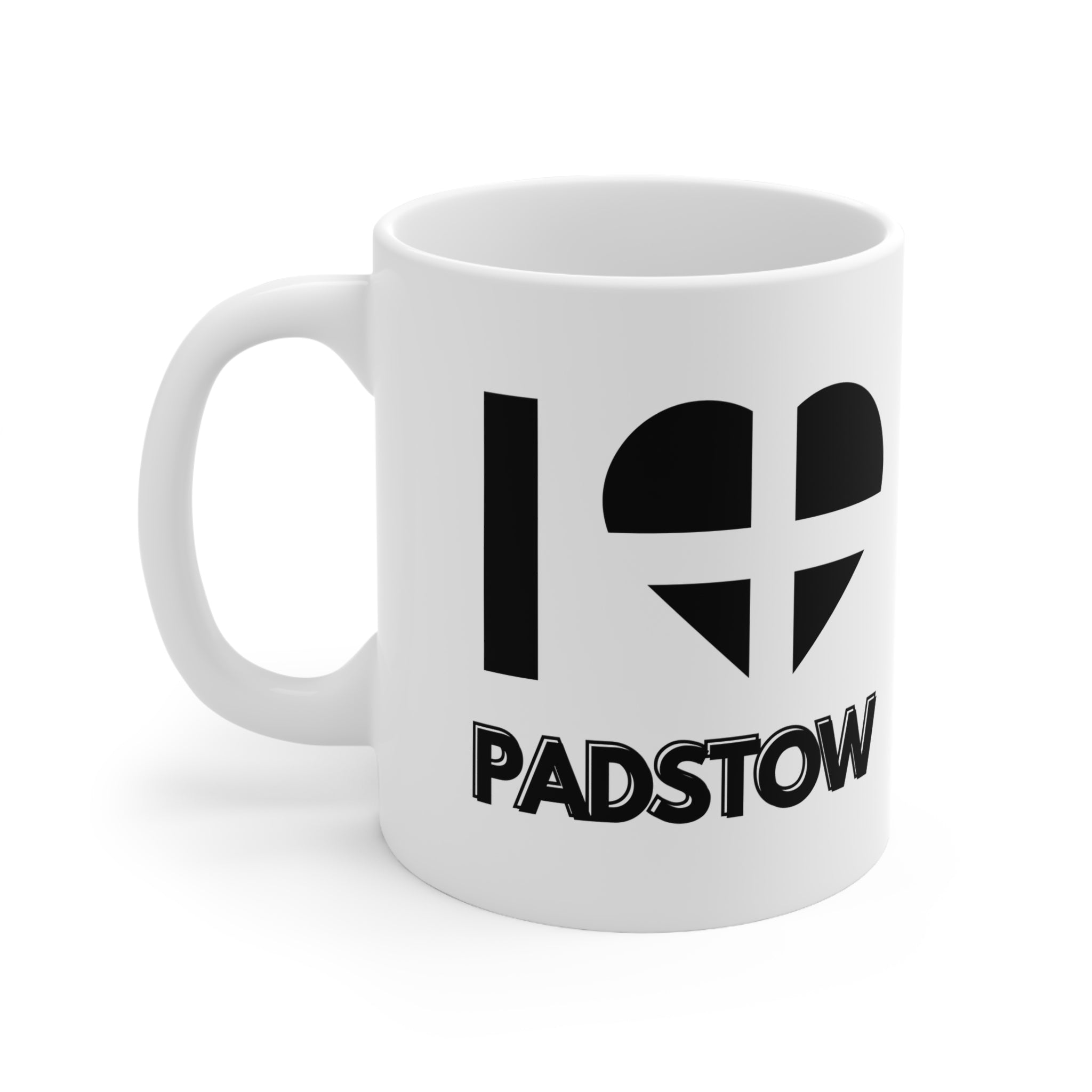 White ceramic mug with the text “I ❤️ Padstow” featuring a heart designed from the Cornish flag – a perfect Cornwall souvenir or Padstow-themed gift.