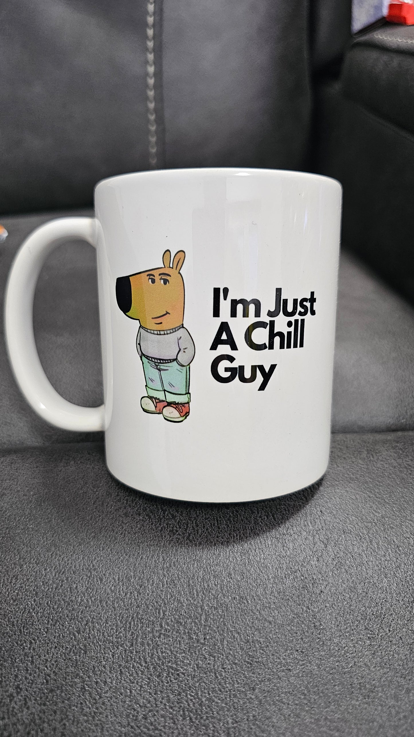 White ceramic mug featuring a cartoon character in jeans and a jumper with the text “I’m Just A Chill Guy” – funny, relaxed coffee cup design.