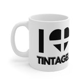 White ceramic mug with the text “I ❤️ Tintagel” and a heart styled in the Cornish flag – a perfect gift for Tintagel Castle visitors and Cornwall lovers.