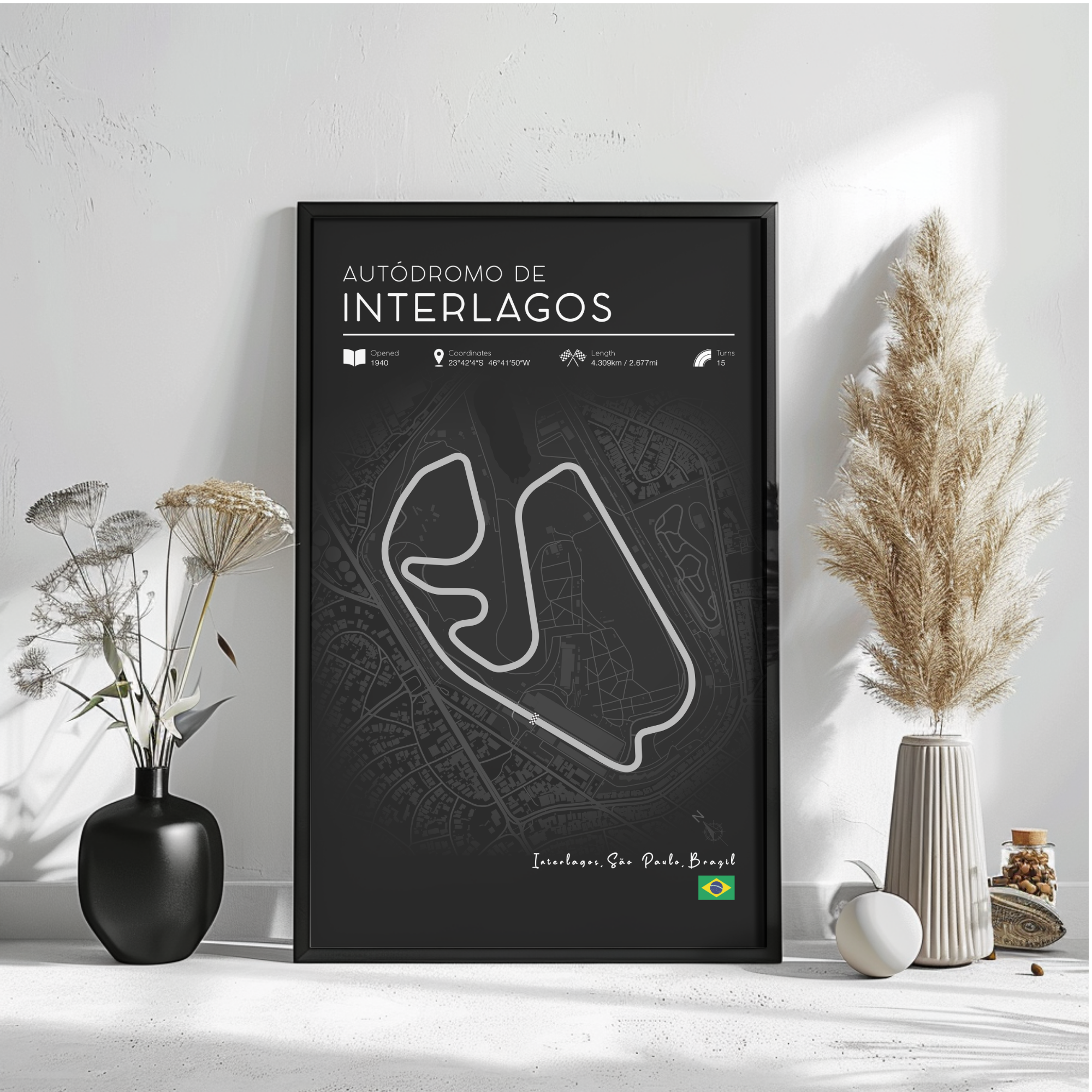 a poster of the Interlagos circuit in Brazil, with a black background and white text. The poster includes a map of the circuit and information about the race track. There are also decorative elements such as a potted plant and a vase on a white surface.