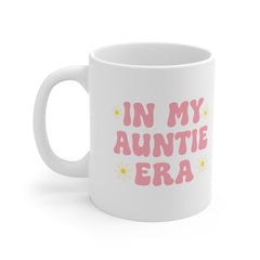 White ceramic mug with pink text reading “In My Auntie Era” and daisy illustrations – a cute and trendy gift for new aunties or auntie announcements.