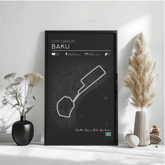 a black poster with a map of the city circuit Baku, along with some decorative elements such as a potted plant and a vase.